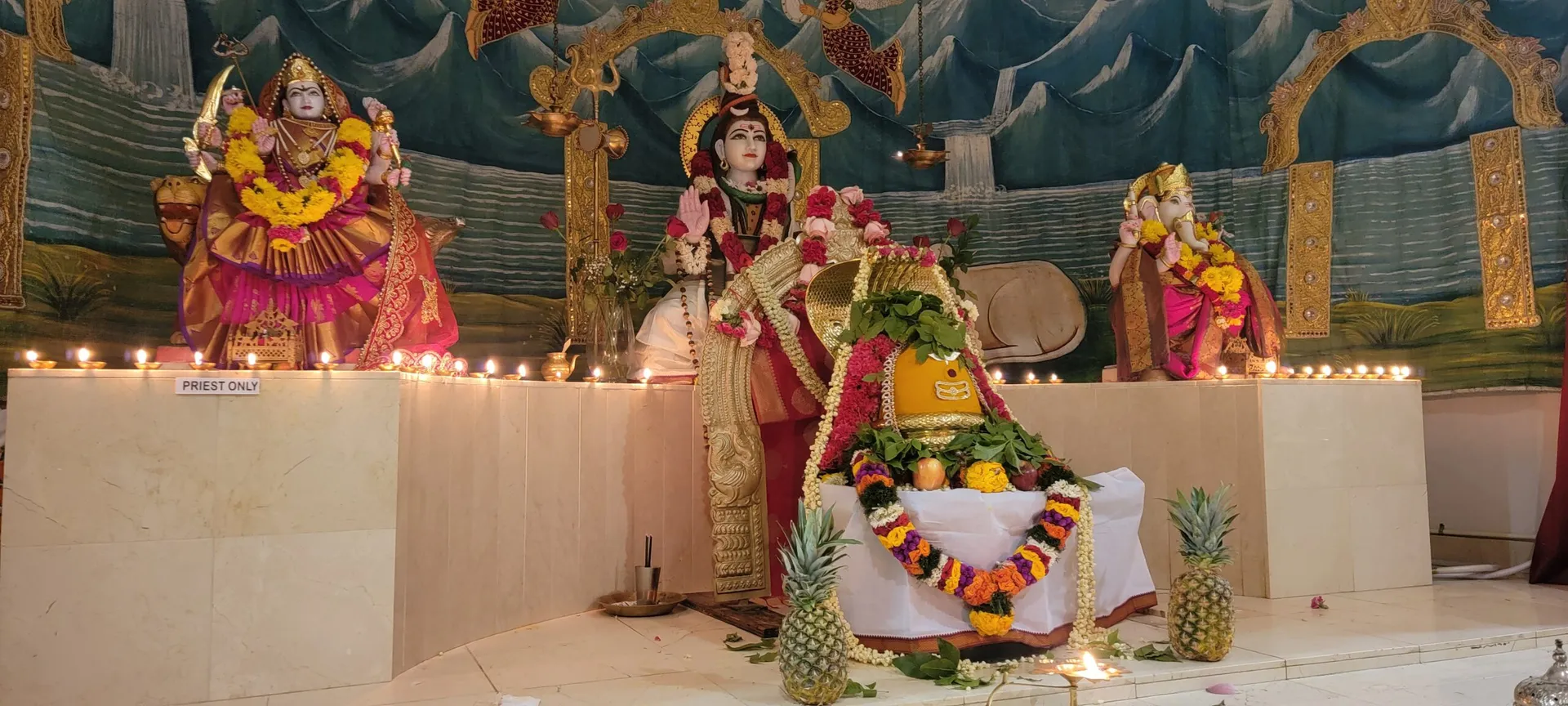 The temple altar, lit with diyas for evening worship