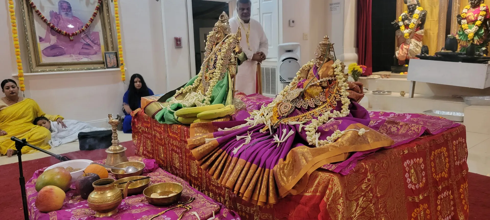 Priests and devotees during worship at the temple