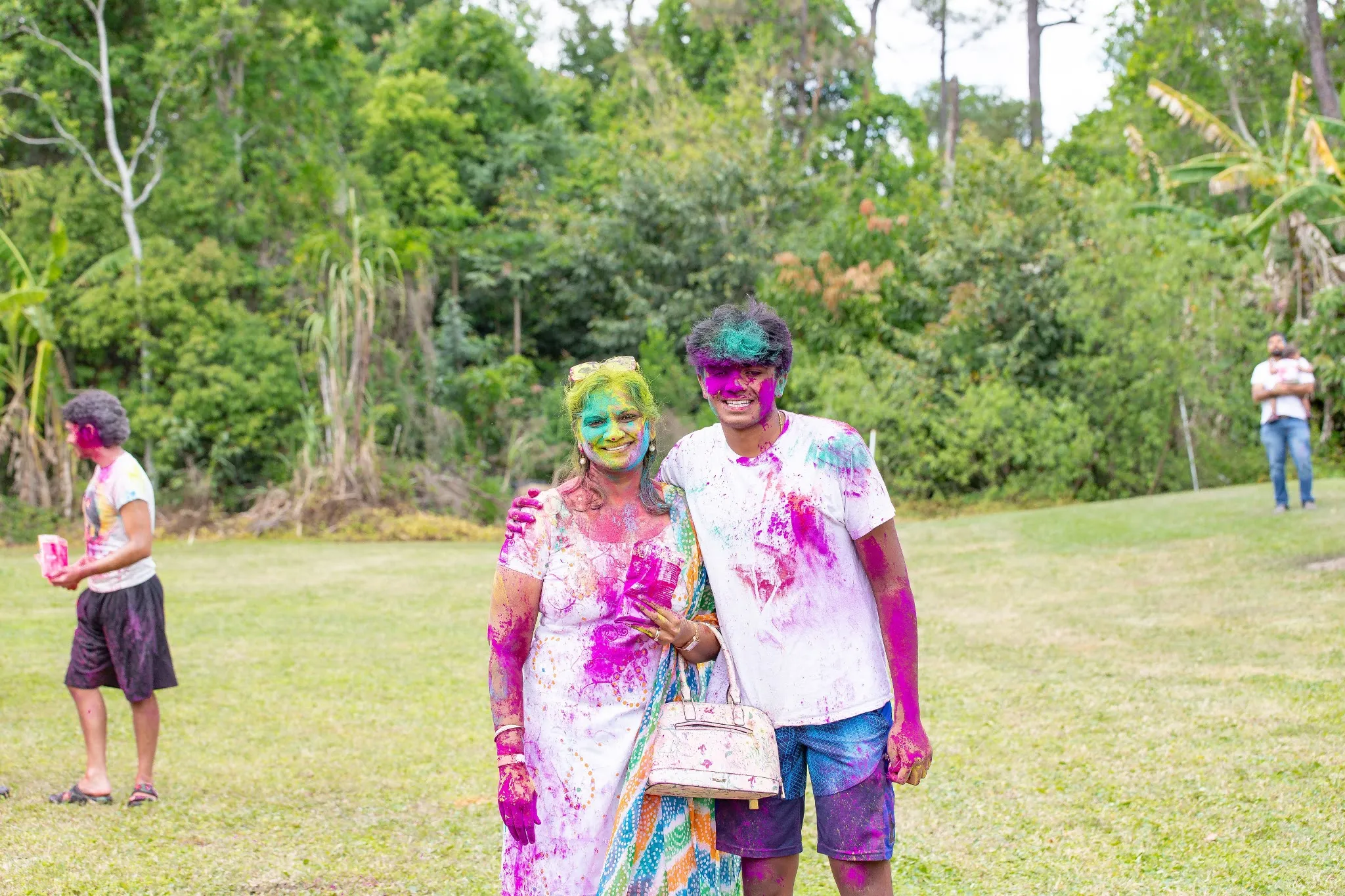 Friends and family celebrating together at the temple's Holi festival